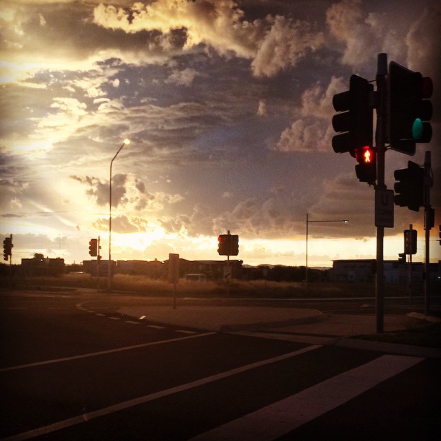 Stormy sunset and street lamps